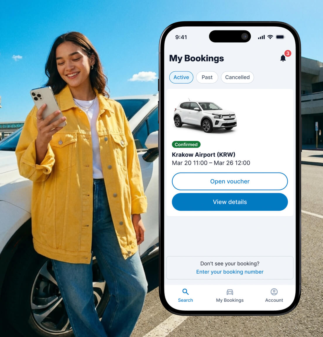 A woman looking at her phone in a parking lot