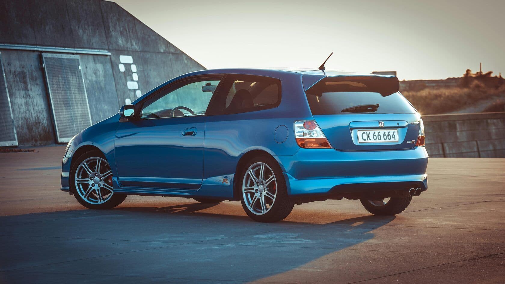 A blue Honda parked