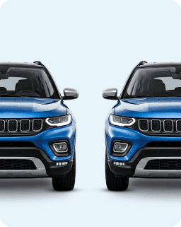 Two blue SUVs from the front