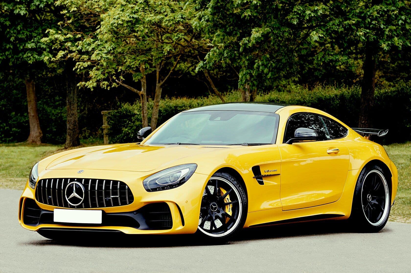 A parked yellow Mercedes-Benz roadster