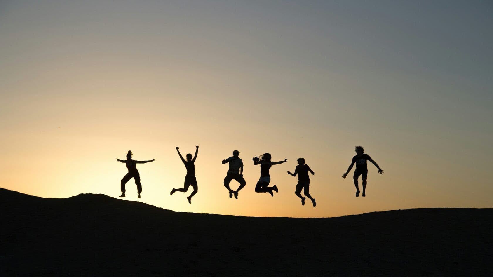 A family jumping during a summer trip
