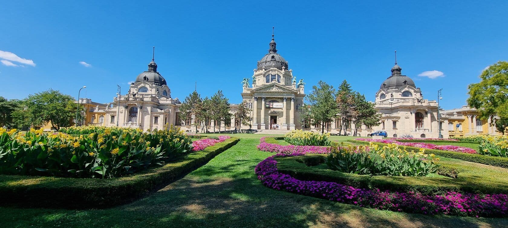 A Széchenyi fürdő impozáns épülete nyáron, népszerű családi úti cél a budapesti vakációhoz