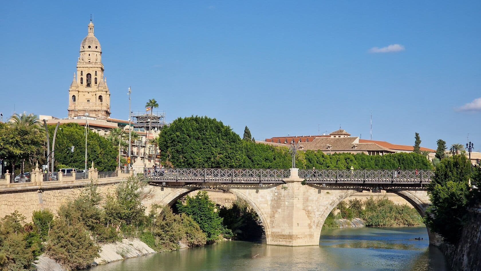 A scenic dinner view in Barcelona with a historical bridge in the background