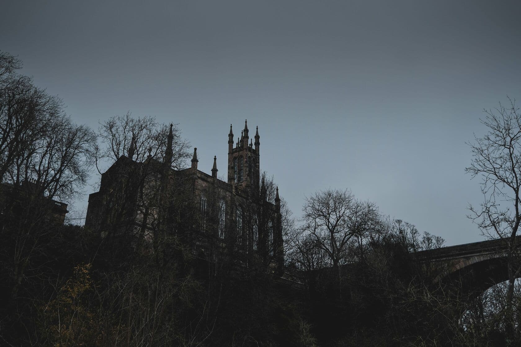 a castle with a bridge in front of it in Edinburgh, Scotland