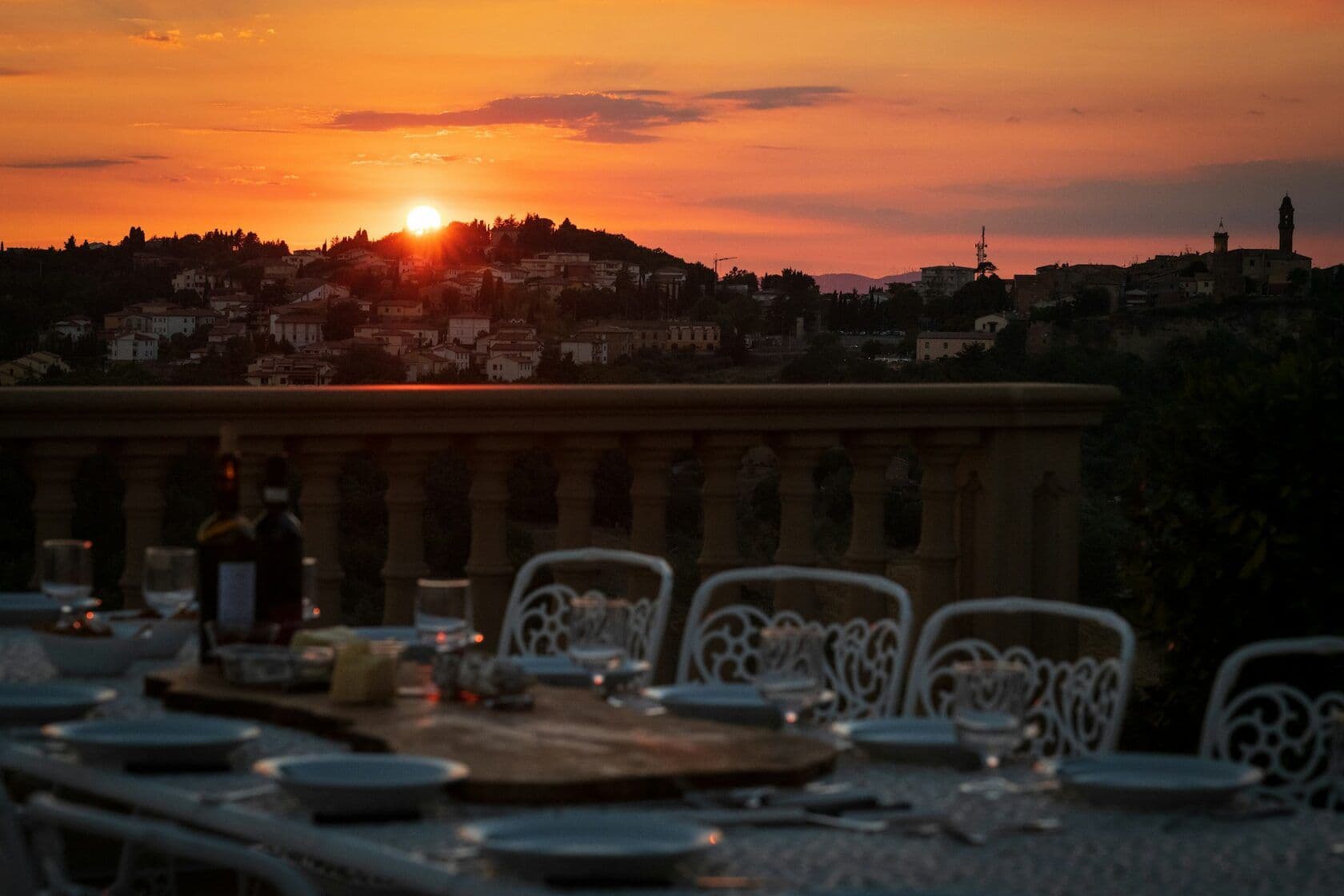 A stunning view of a European sunset from a table set for dinner